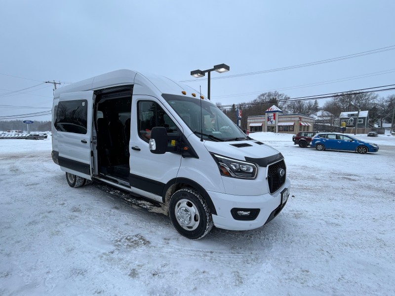 Kasper minibus - a white van with the side door slid open - in a parking lot