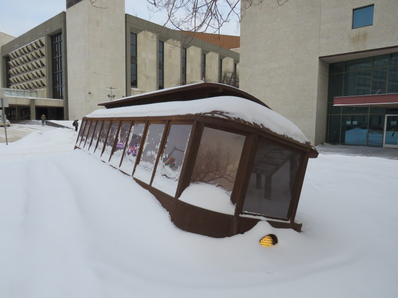 The monument to the 1919 Winnipeg General Strike; a Corten steel replica of a toppled streetcar, covered in snow